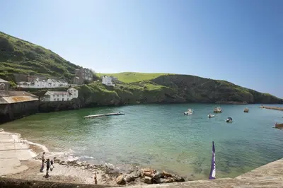 a view of a beach with boats in the water at Castle Cottage, Port Isaac Bay Holidays in Port Isaac