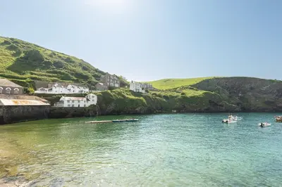 a group of boats in a body of water at Castle Cottage, Port Isaac Bay Holidays in Port Isaac
