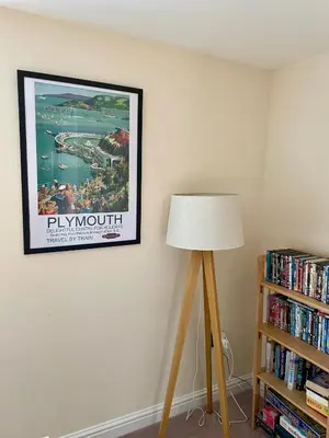 a lamp in a room with a picture on the wall at The Coach House in Par
