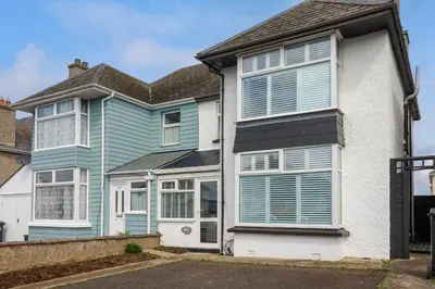 a house with blue shutters on it at 119 Henver Road in Newquay