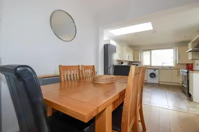 a kitchen and dining room with a wooden table and chairs at 119 Henver Road in Newquay