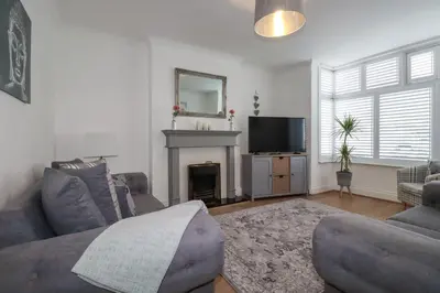 a living room with a couch and a television at 119 Henver Road in Newquay