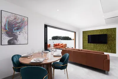 a living room with a table and a couch at Brand new, Gwithian lodge, eco home in Praze an Beeble