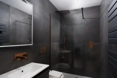 a bathroom with a shower and a sink and a toilet at Brand new, Gwithian lodge, eco home in Praze an Beeble