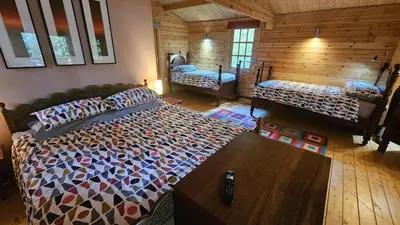 a bedroom with a large bed in a room at Roseland Valley Retreat in Tregoney