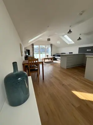 a living room with a vase sitting on a table at The Boathouse in Mylor Bridge