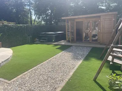 a small garden with a barbecue in a backyard at Stunning 4 Bed Pet Friendly Cottage with Hot Tub in Bodmin
