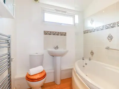 a bathroom with a toilet and a sink and a tub at Cornish Holiday at Atlantic Bays in St Merryn