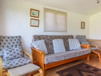 a living room with a couch and two chairs at Cornish Holiday at Atlantic Bays in St Merryn