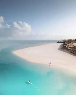 an aerial view of a beach with blue water at Cornish Highbury in Hayle