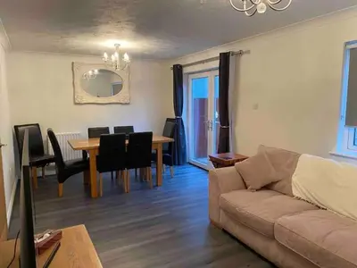 a living room with a couch and a dining room table at Cornish Highbury in Hayle