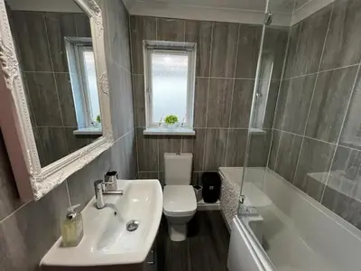 a bathroom with a sink and a toilet and a tub at Cornish Highbury in Hayle