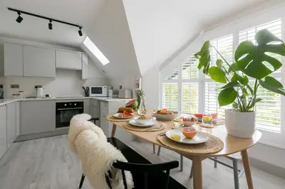 a kitchen with a table with food on it at Westholme in St Ives