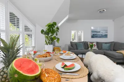 a living room with a table with food on it at Westholme in St Ives