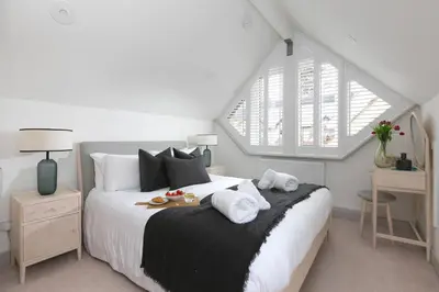 a bedroom with a large bed with towels on it at Westholme in St Ives