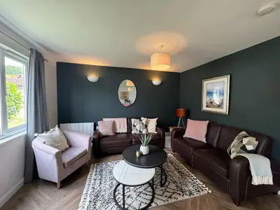 a living room with a couch and a table at 3 Bedroom lodge Hengar Manor sleeps 6 115 in Michaelstow