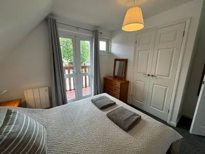 a bedroom with a bed with two pillows on it at 3 Bedroom lodge Hengar Manor sleeps 6 115 in Michaelstow