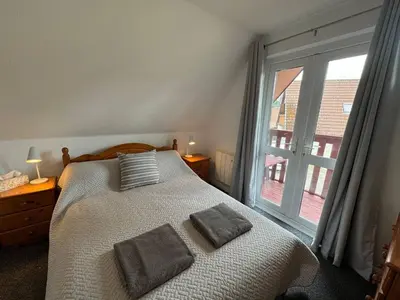 a bedroom with a bed and a large window at 3 Bedroom lodge Hengar Manor sleeps 6 115 in Michaelstow