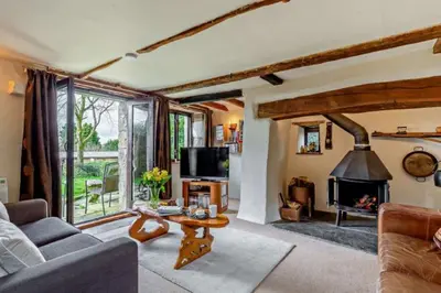 a living room with a couch and a fireplace at Tawnawood by Together Travel - Luxury Cornish Countryside Retreat in Bodmin