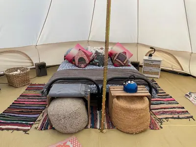 a bedroom with a bed in a tent at Glamping Meadow Bell Tent in Stithians