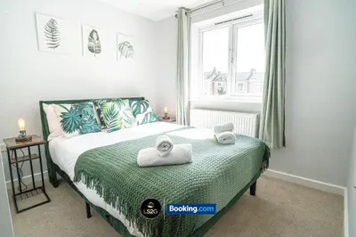 a bedroom with a bed with towels on it at Spacious 2 Bedroom Flat By LS2G Short Lets & Serviced Accommodation Greater London With Free WIFI in Newquay