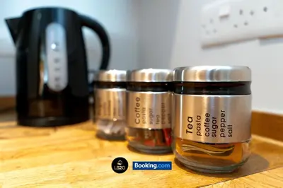 a group of spice jars sitting on top of a counter at Spacious 2 Bedroom Flat By LS2G Short Lets & Serviced Accommodation Greater London With Free WIFI in Newquay