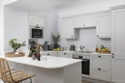 a kitchen with white cabinets and a white counter top at The Elms in Uny Lelant