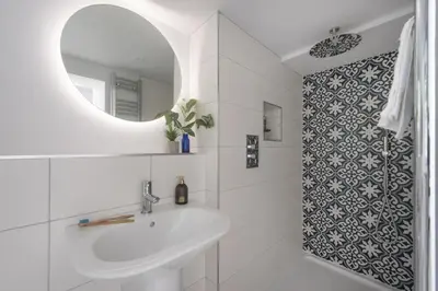 a white bathroom with a sink and a mirror at The Elms in Uny Lelant
