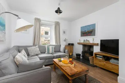 a living room with a couch and a coffee table at Benjamin's Bolthole in St Ives