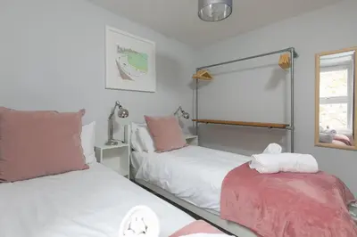 a bedroom with two beds and a window at Benjamin's Bolthole in St Ives