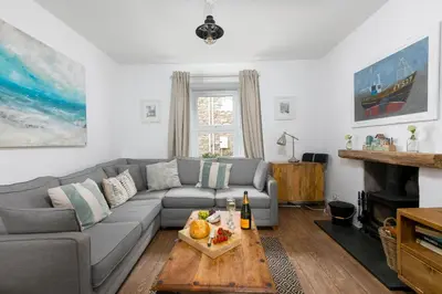 a living room with a couch and a table at Benjamin's Bolthole in St Ives