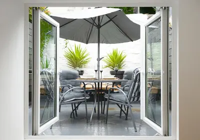 a table and chairs with an umbrella on a patio at The Flat - Brand new renovation in amazing location in St. Agnes