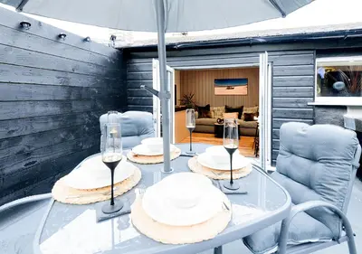 a glass table with wine glasses on top of it at The Flat - Brand new renovation in amazing location in St. Agnes