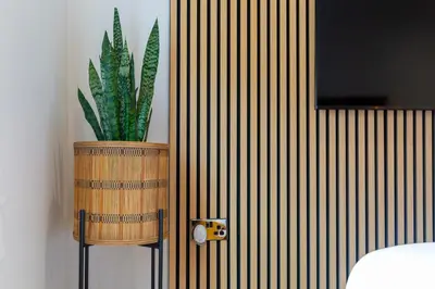 a potted plant in a wooden barrel in a room at The Flat - Brand new renovation in amazing location in St. Agnes