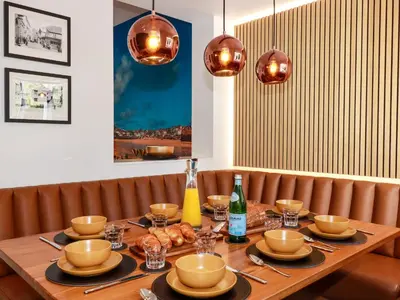 a wooden table with plates and glasses on it at Sea Candy in St Ives