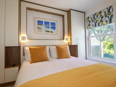 a bedroom with a bed and a large window at Sea Candy in St Ives