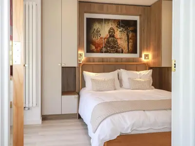 a bedroom with two beds and a painting on the wall at Sea Candy in St Ives