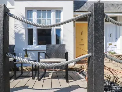 a rope around a table and a chair on a patio at Sea Candy in St Ives