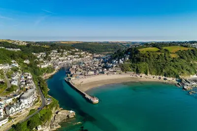 an aerial view of a beach with a boat in the water at Swallows Rest Cottage - 3 Bedrooms - Nr Looe in Looe