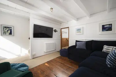 a living room with a couch and a flat screen tv at No 1 St Eia, St Ives in St Ives