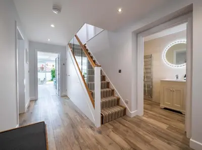 a hallway with a staircase in a house at Padstow Escapes - Trenemere in Padstow