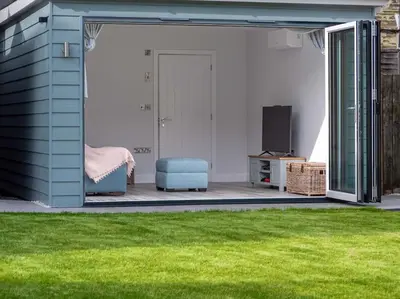 a living room with a door open to a yard at Padstow Escapes - Trenemere in Padstow