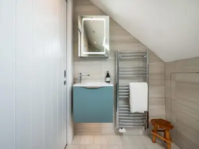 a bathroom with a sink and a mirror at Padstow Escapes - Trenemere in Padstow