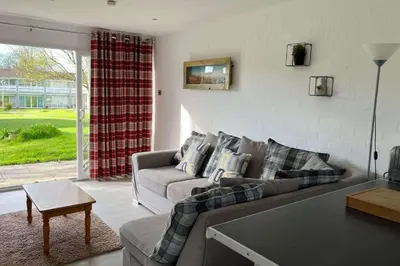 a living room with a couch and a table at 2 Bed Cottage Sleeps 5 - Pets Allowed in Newquay