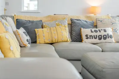 a gray couch with many pillows on it at 4 Bed in Newquay oc-b29882 in Newquay