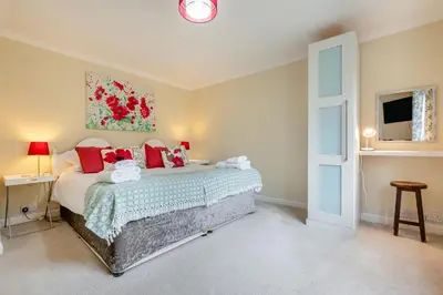 a bedroom with a large bed with red pillows at 4 Bed in Newquay oc-b29882 in Newquay
