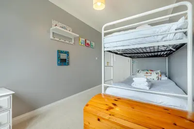 a bedroom with a bunk bed with a wooden floor at 4 Bed in Newquay oc-b29882 in Newquay