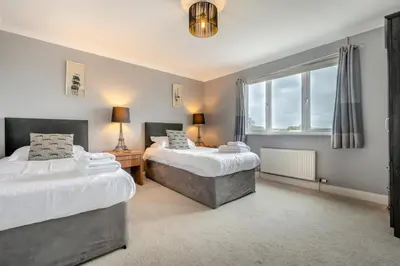 a bedroom with two beds and a window at 4 Bed in Newquay oc-b29882 in Newquay
