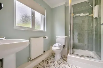 a bathroom with a toilet and a sink and a shower at 4 Bed in Newquay oc-b29882 in Newquay