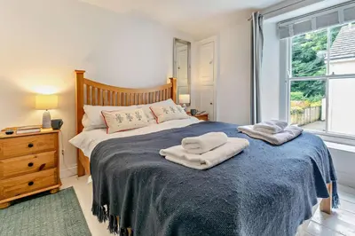 a bedroom with a bed with two towels on it at 5 Bed in Padstow oc-s29853 in Padstow